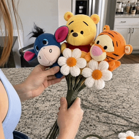 A handmade character bouquet being carefully assembled