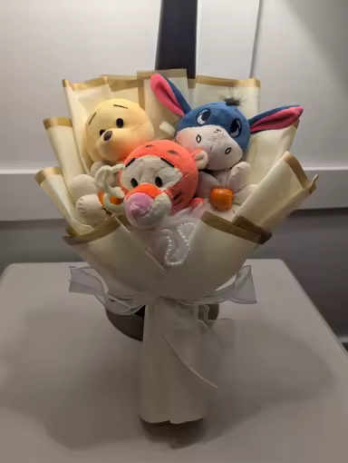 Customer-received bear, tiger, and donkey crochet bouquet in ivory wrapping
