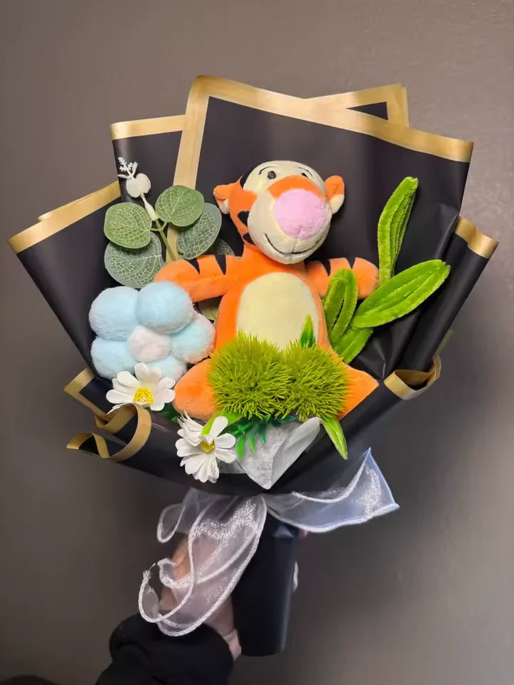 Customer-received orange tiger crochet bouquet in black and gold wrapping